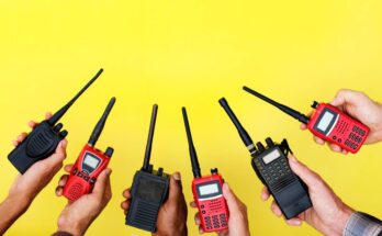 Six hands holding up red and black two-way radios in an alternating color pattern in front of a yellow background.