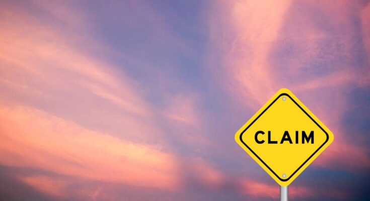 A yellow diamond-shaped sign reads "claim" in black, bold letters. A pink and purple sunset is in the background.