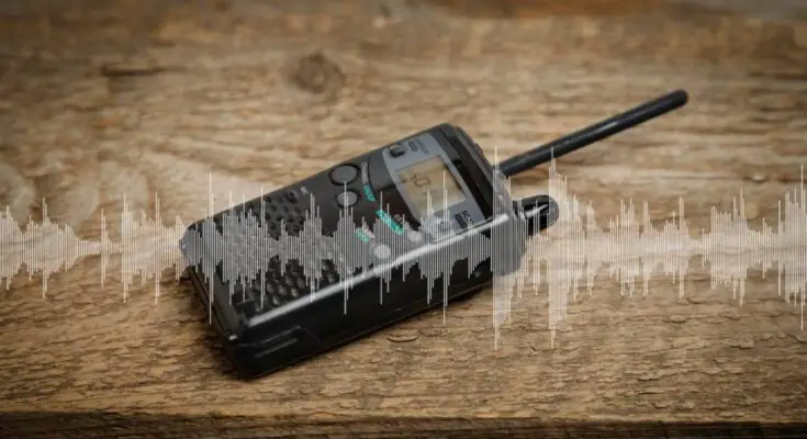 A black two-way radio sitting on top of a wooden table with a noisy wave signal overlaid on top of them.