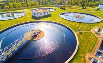 An aerial view of a water management and sewage treatment plant. There are four large water treatments.