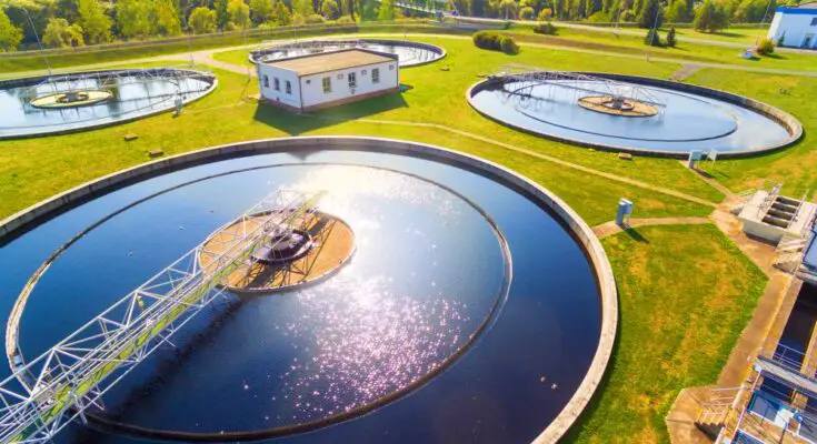 An aerial view of a water management and sewage treatment plant. There are four large water treatments.