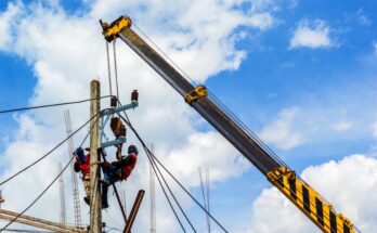 An electrical crew working on a utility pole. They're relying on quality rigging gear and supplies for hoisting.