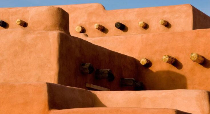 Close-up on the subtle details of the type of lovely orange adobe home found most often in New Mexico.