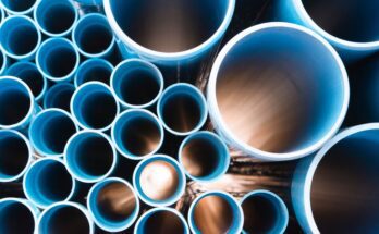 A head-on view of an array of plastic pipes. The pipes are blue and various sizes