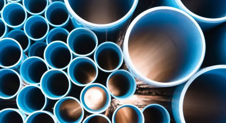 A head-on view of an array of plastic pipes. The pipes are blue and various sizes