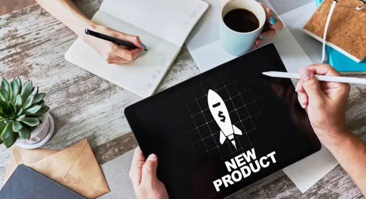 A person holds a tablet and stylus in their hands. The tablet reads "new product" and shows an image of a rocket.